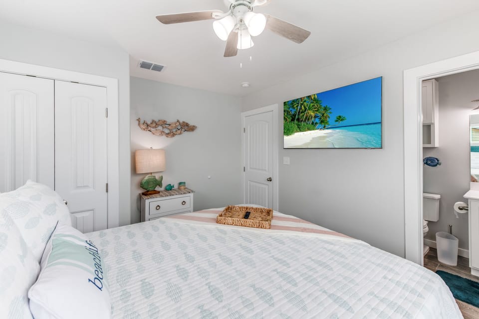 Drift off to sleep in your coastal-themed bedroom, where beach artwork and soothing colors create your perfect seaside retreat.