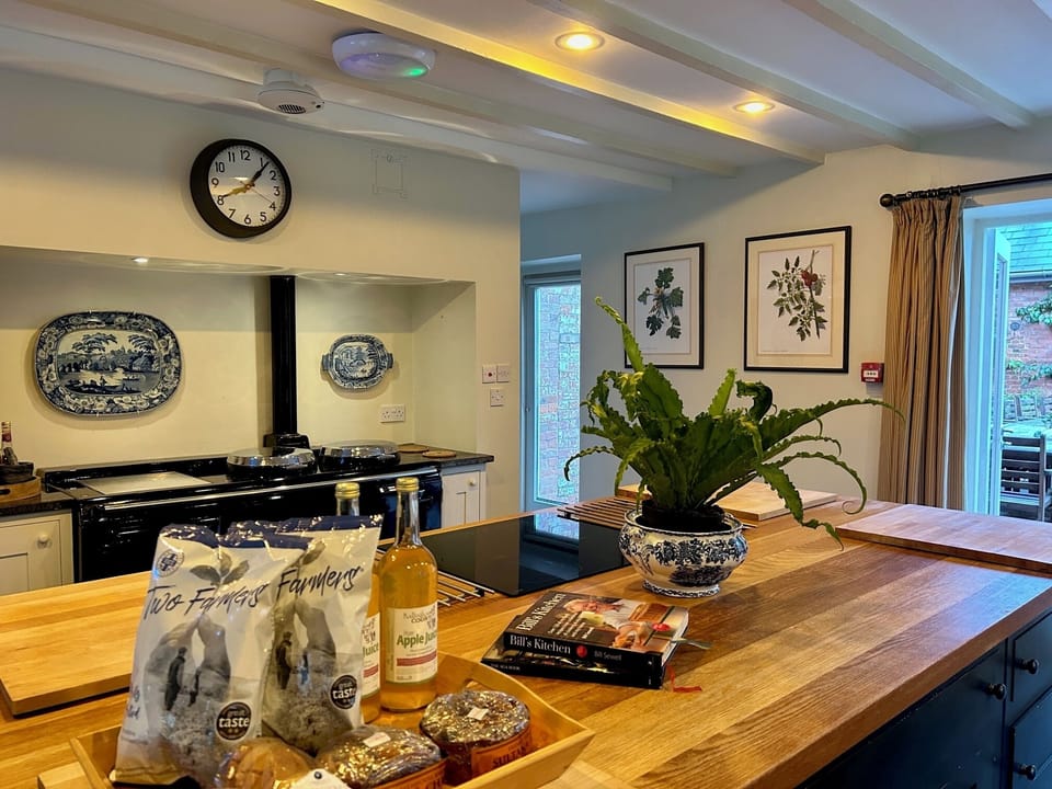Great working kitchen with huge island and aga.  French doors lead to outside 