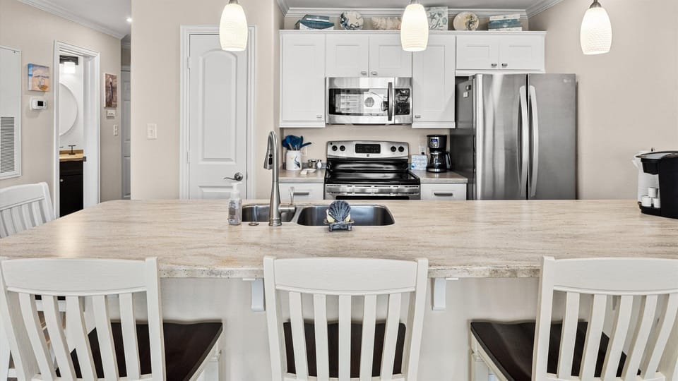 Enjoy easycare quartz counters and stainless appliances.