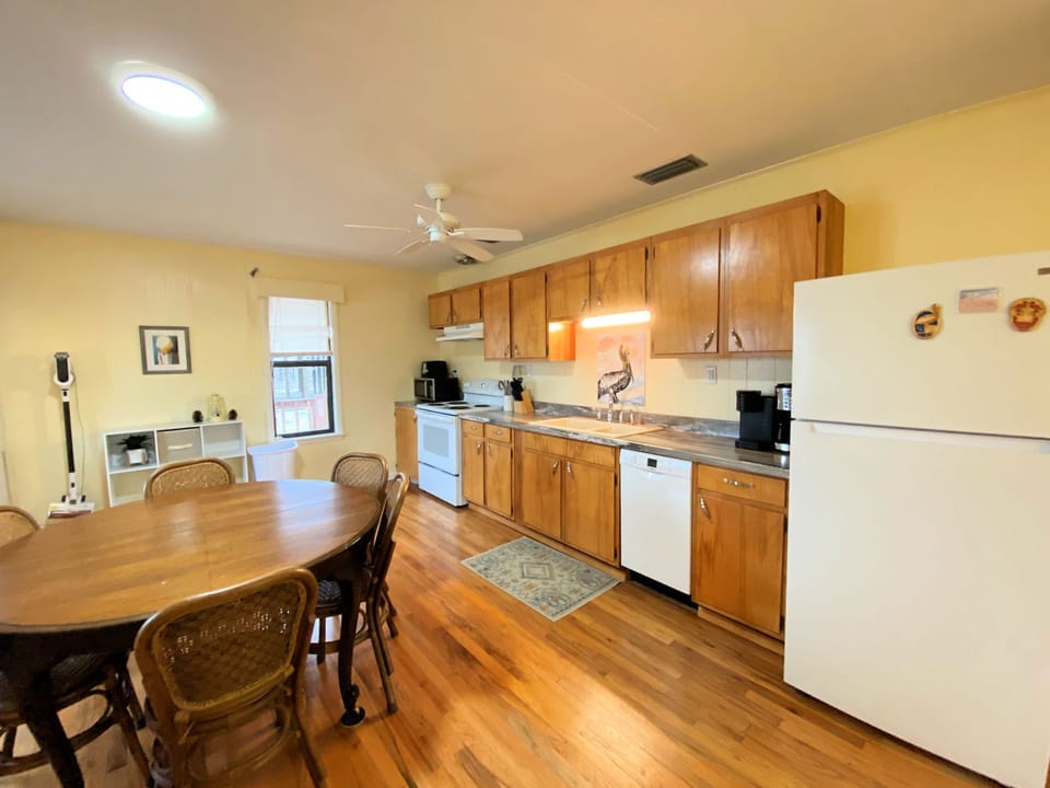 Your spacious kitchen welcomes you with warm wood cabinets, appliances, and hardwood floors for memorable meal preparation.