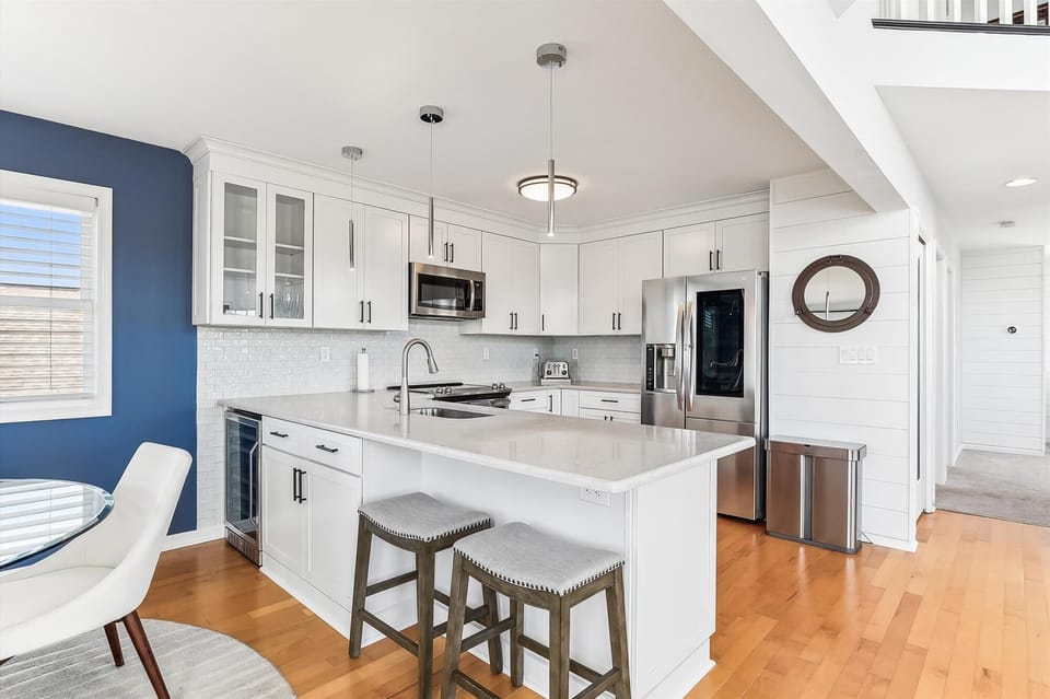 Step into your bright, modern kitchen—white cabinetry, sleek countertops, and stainless steel appliances make cooking a joy. Enjoy meals at the island or unwind by the window.