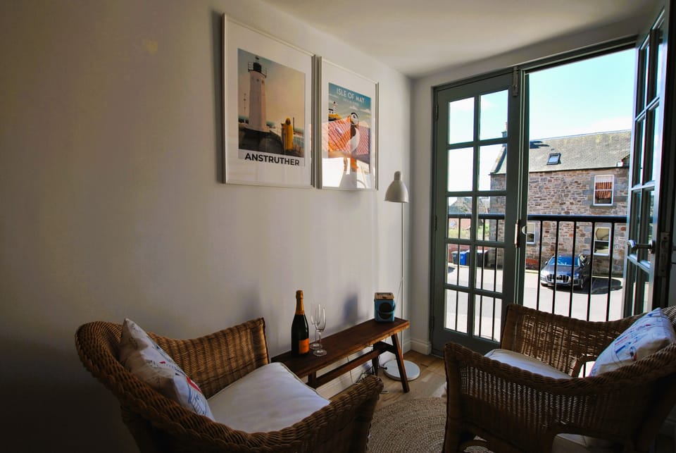 The first floor has a seating area by the balcony doors