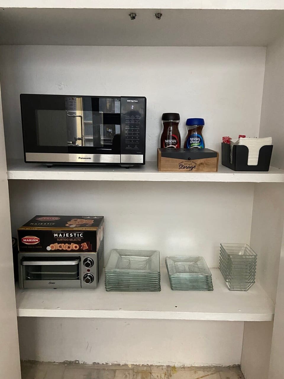 Microwave, toaster oven, and essential dishware provided for easy meals.