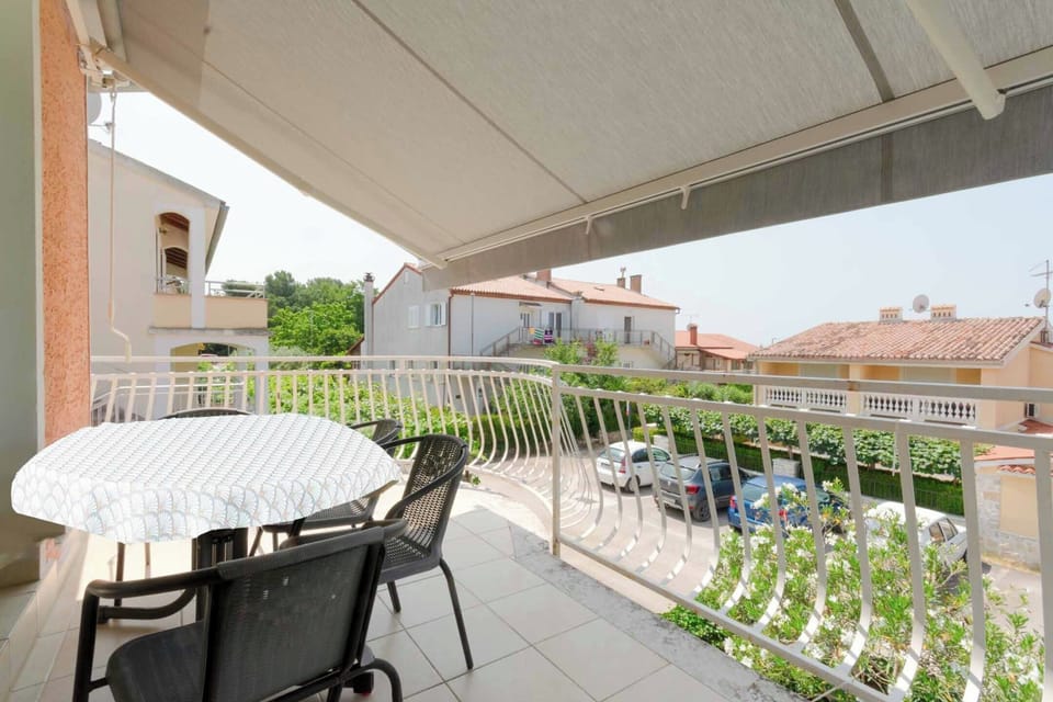 Big balcony with retractable awning and seating furniture.
