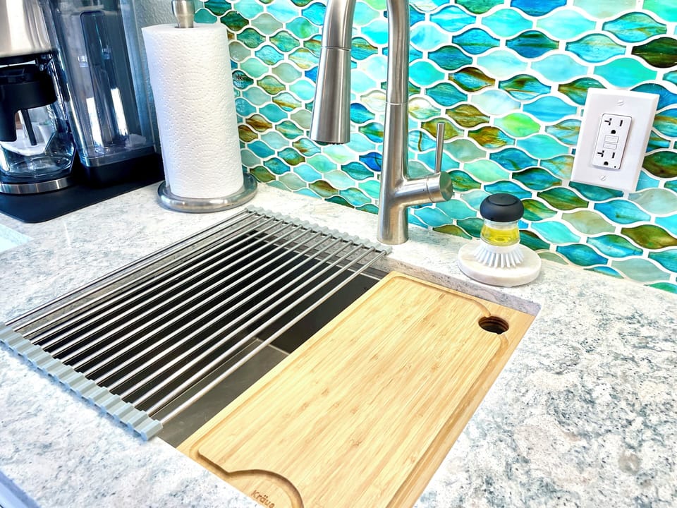 Locking cooktop, over sink drying rack & cutting board increase counter space.