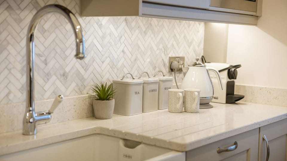 Porte House modern kitchen detail with marble worktop, kettle and coffee machine.