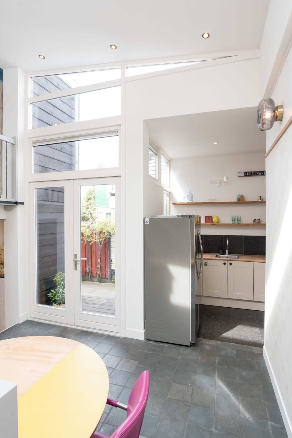 Cook, dine, and enjoy direct access to the private terrace — this kitchen combines function with loads of natural light.