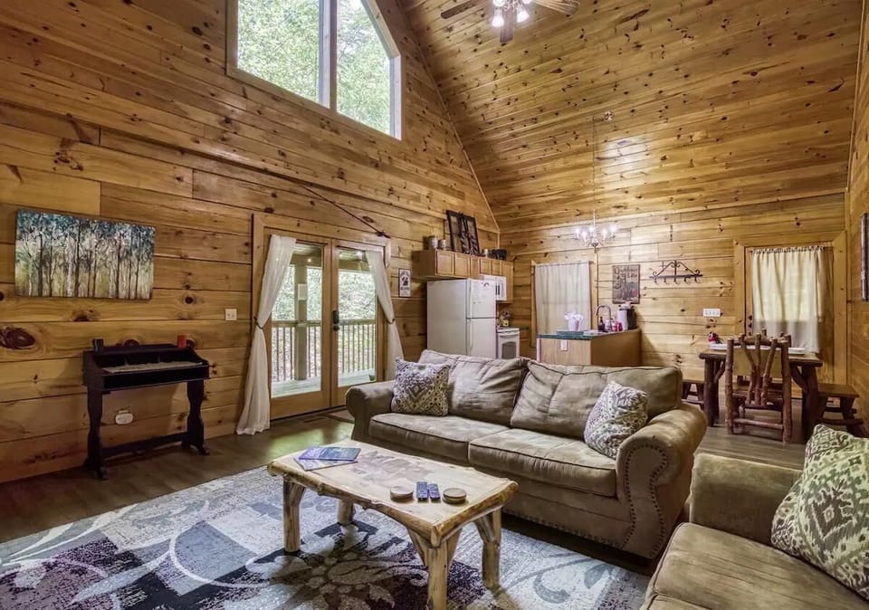 Living Room: Natural wood accents enhance the bright, airy space with a view of nature!