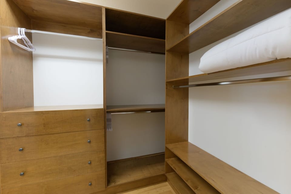 This photo doesn't quite capture how large the walk-in closet is.. so imagine it double the size with a huge wall mounted full length mirror--it's a great spot for getting ready for a night out on the town. 