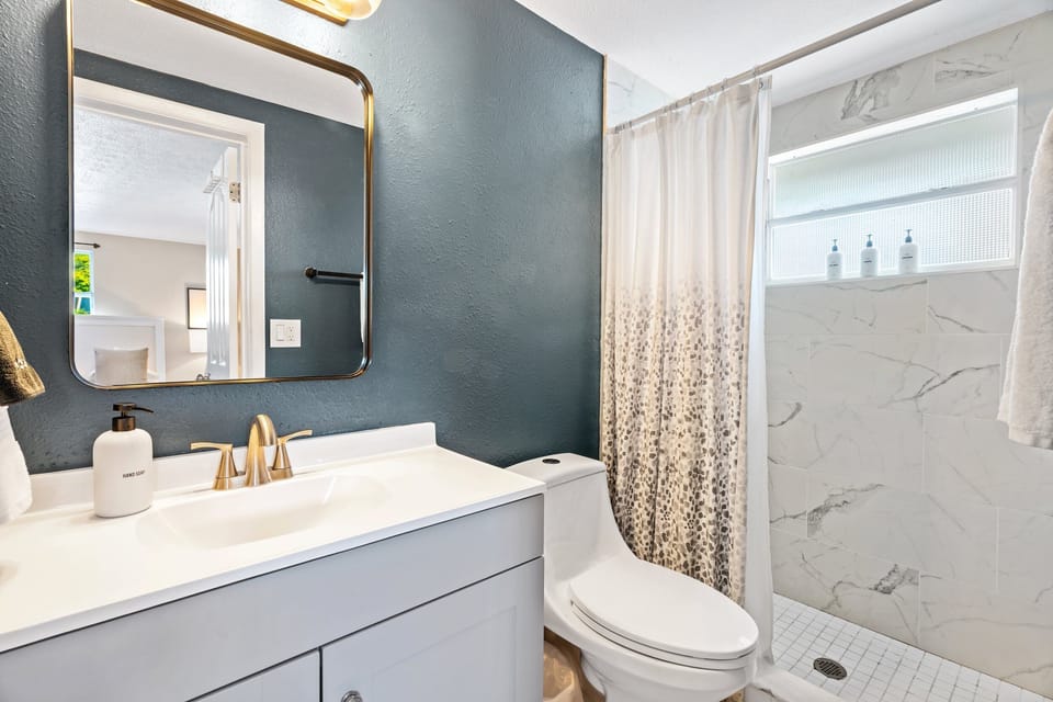 Bathroom 1: Full bath with standing shower located just off the primary bedroom.