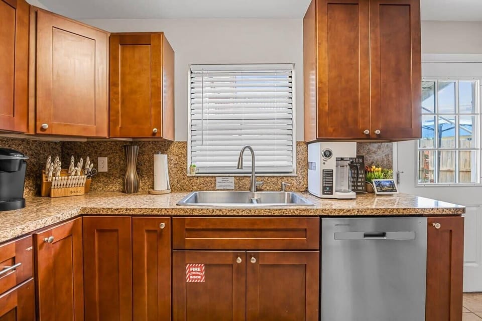 Modern kitchen with granite countertops and stainless steel dishwasher