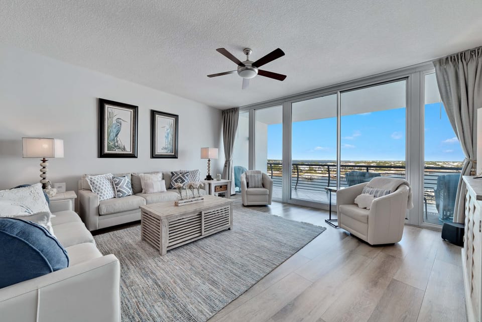 Spacious and inviting living area with floor-to-ceiling windows showcasing breathtaking panoramic views. This open-concept design seamlessly blends comfort and style, creating the perfect space for relaxation and entertainment.