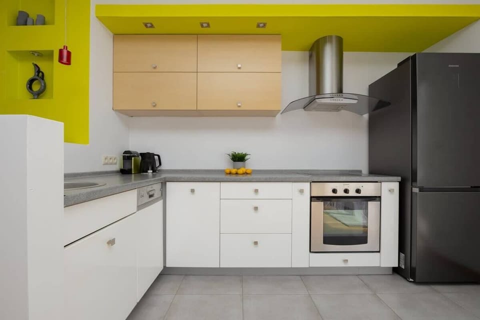 The sleek design of the kitchenette blending seamlessly with the living area.
