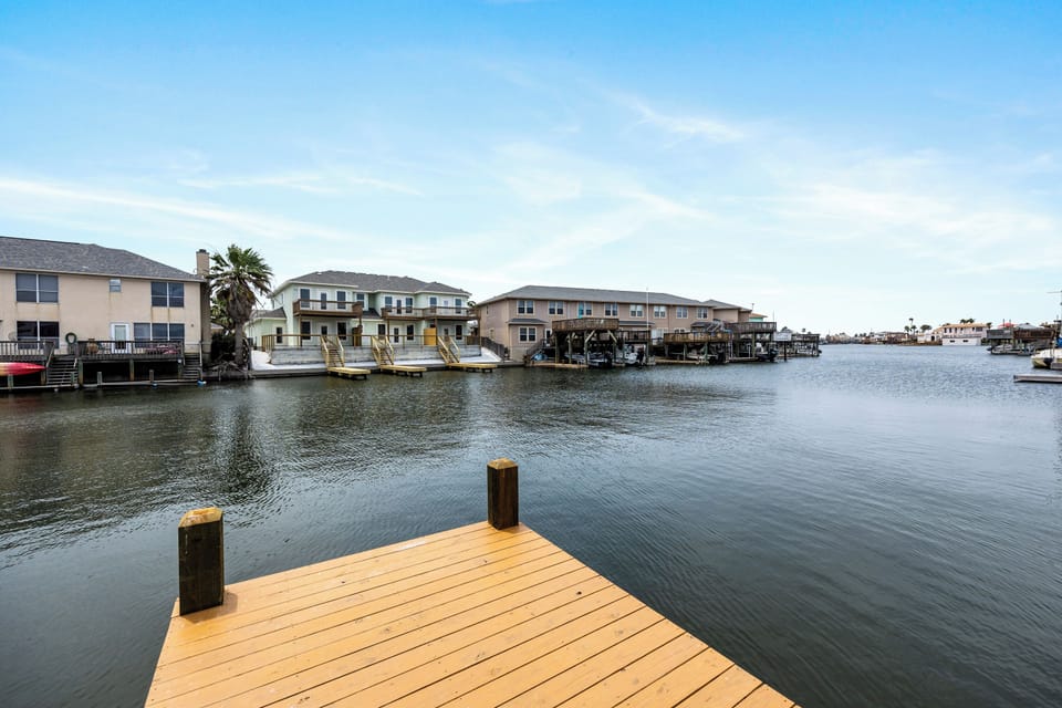 Waterfront property with private dock on calm canal waters, surrounded by peaceful residential community.