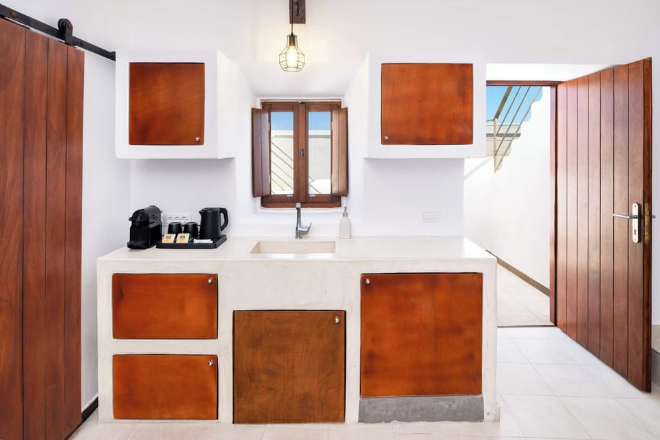 Modern Kitchenette with Wooden Cabinets and Smart TV