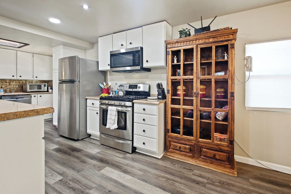 Enjoy a full kitchen with a gas range, microwave, refrigerator and cookware