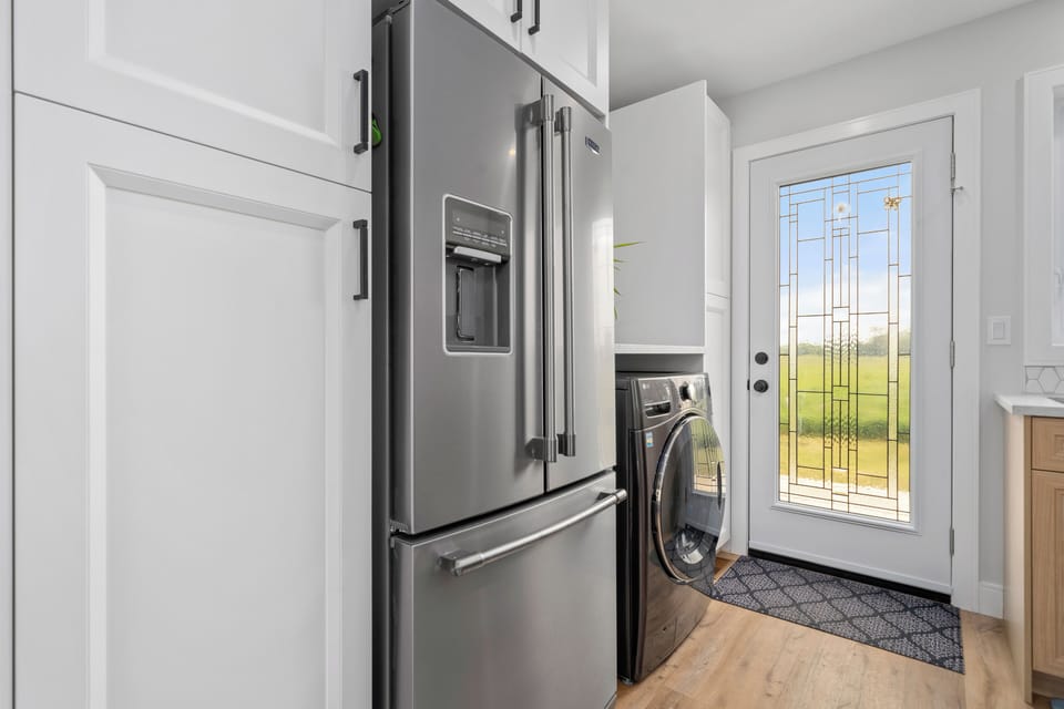 Full-sized refrigerator, combo washer/dryer and back door to porch.