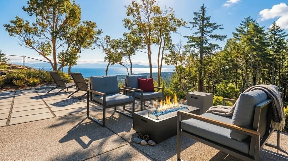 Scenic patio with fire table, lounge seating, and stunning water views