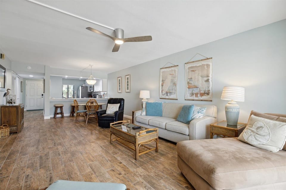 The living room is spacious and has plenty of seating, making it a perfect spot for a relaxing day.