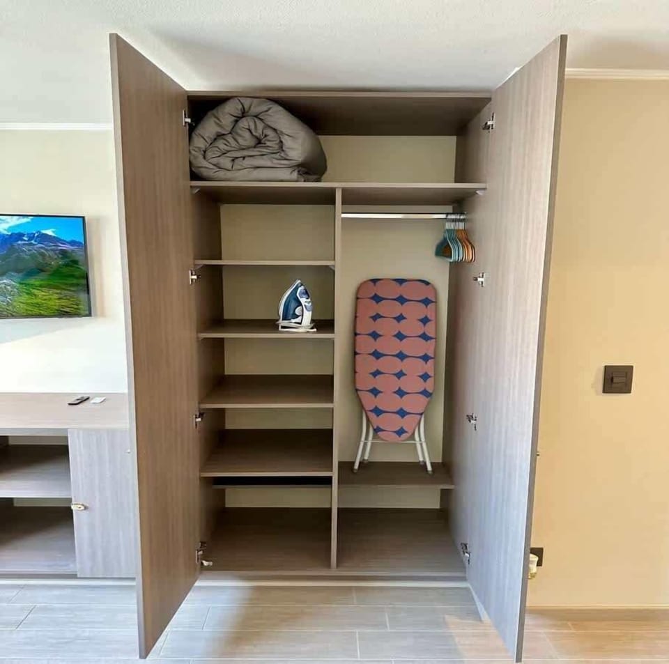 Open wardrobe w/ shelving & hanging space for easy unpacking