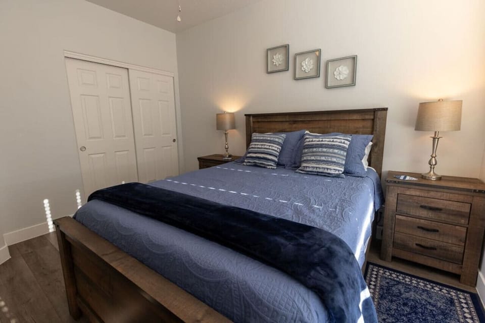 The guest room offers a comfortable queen bed with closet and clothes storage space in the dresser.