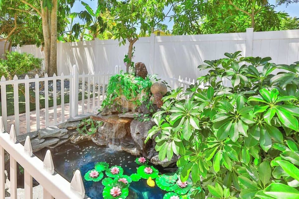 Discover tranquility in the backyard of Pondside Funhouse, our vacation rental in Pinellas Park, FL, where a charming decorative pond sets the scene. Lounge in the hammock and drift away to the soothing sound of water trickling nearby.