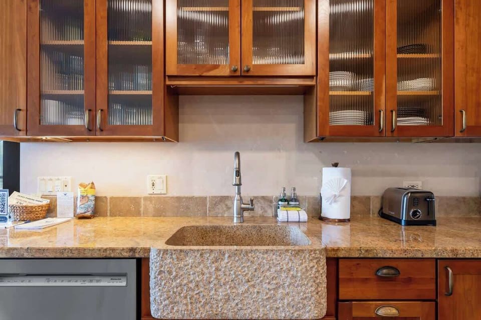 Custom kitchen sink and fully stocked cabinets 
