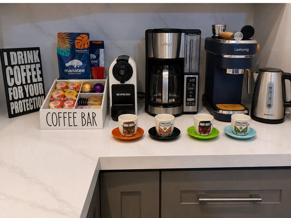 Stocked coffee bar including Espresso, Drip, and Cappuccino, Electric tea kettle