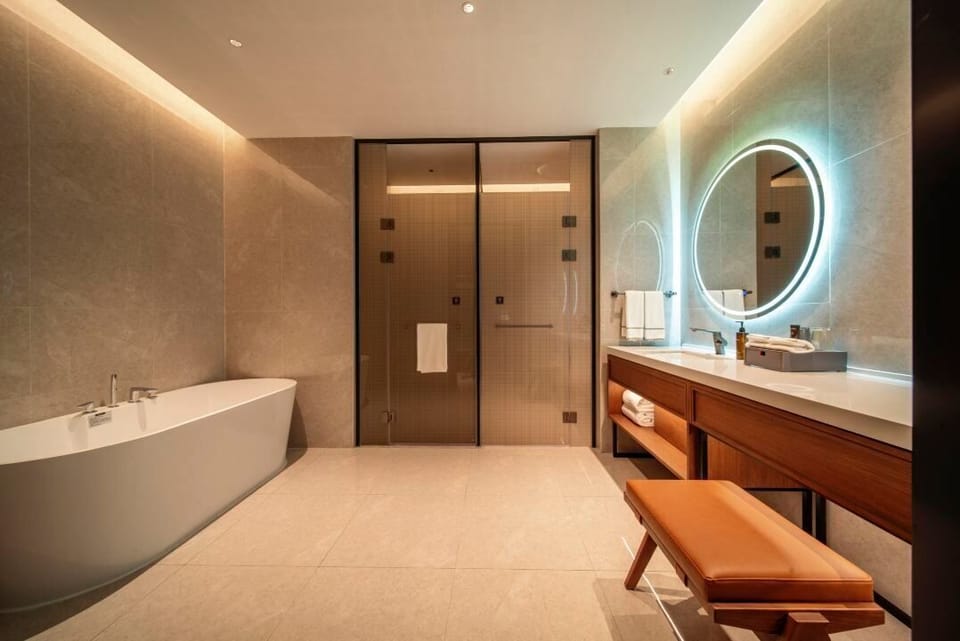 Executive Grand King | Bathroom | Designer toiletries, hair dryer, slippers, towels