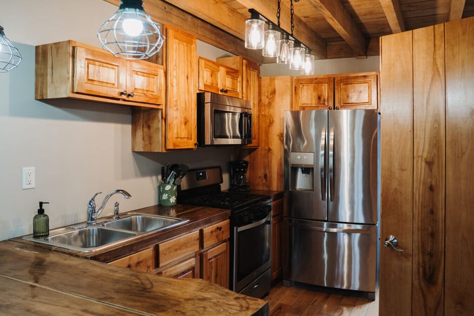 Experience the seamless flow between the kitchen, dining room, and living room, perfect for gatherings. Revel in the charm of this exquisitely crafted cabin, where every detail is designed for your comfort.