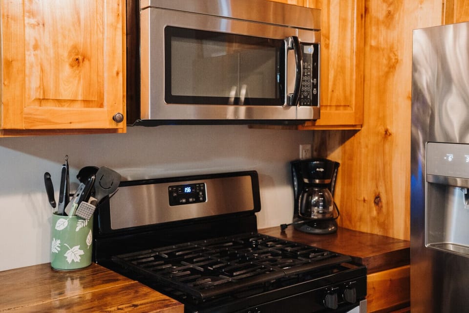 Experience the seamless flow between the kitchen, dining room, and living room, perfect for gatherings. Revel in the charm of this exquisitely crafted cabin, where every detail is designed for your comfort.