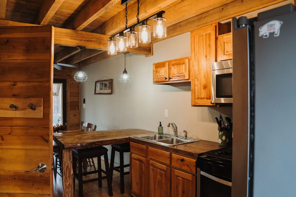 Experience the seamless flow between the kitchen, dining room, and living room, perfect for gatherings. Revel in the charm of this exquisitely crafted cabin, where every detail is designed for your comfort.