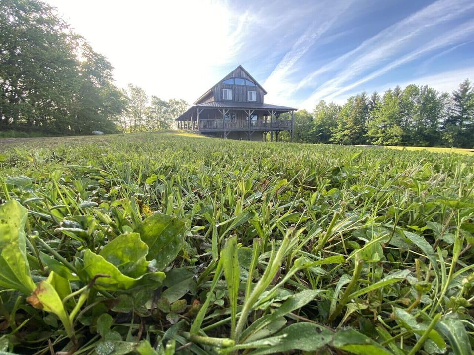 Discover The Lodge, the perfect retreat for up to 14 guests, featuring breathtaking views and endless outdoor fun. Enjoy the wrap-around deck, volleyball court, fire pit, hot tub, and yard games for unforgettable memories!