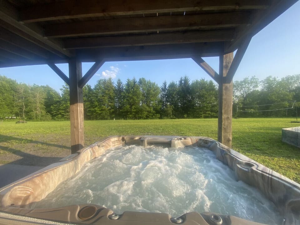 Discover The Lodge, the perfect retreat for up to 14 guests, featuring breathtaking views and endless outdoor fun. Enjoy the wrap-around deck, volleyball court, fire pit, hot tub, and yard games for unforgettable memories!