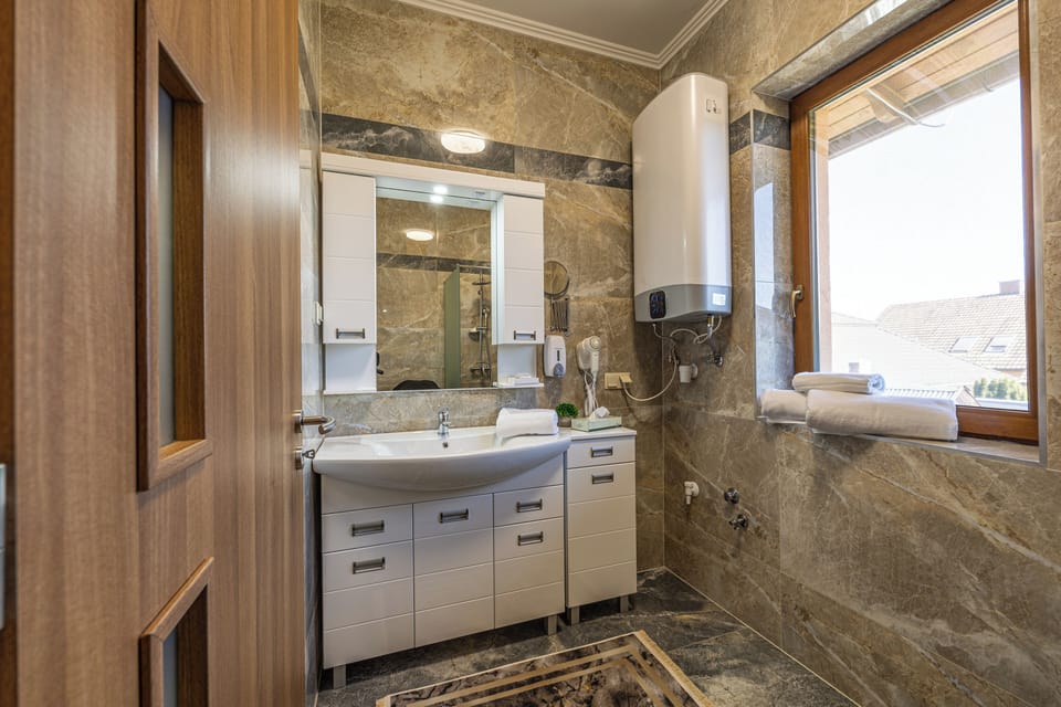 Family Room | Bathroom | Shower, rainfall showerhead, slippers, towels