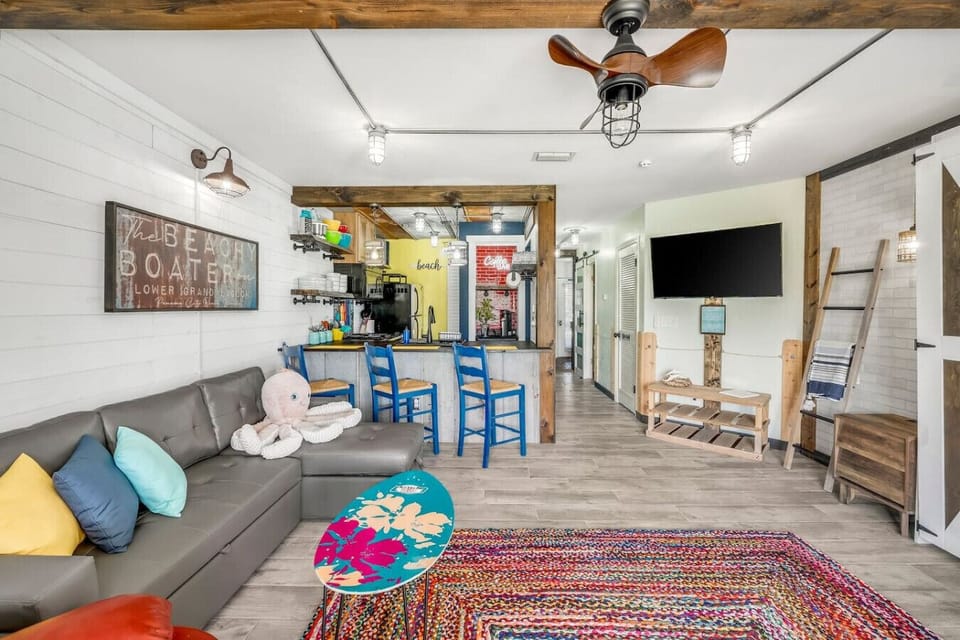 Lagoon Front Living Area with Full Size Sleeper Sofa, Queen Size Murphy Bed, Flat Screen TV and Private Patio Access