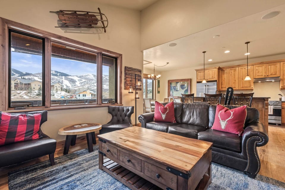 Sink into the leather seating and take in stunning mountain and ski resort views from the comfort of your open-plan living space, where rustic charm meets modern alpine elegance.