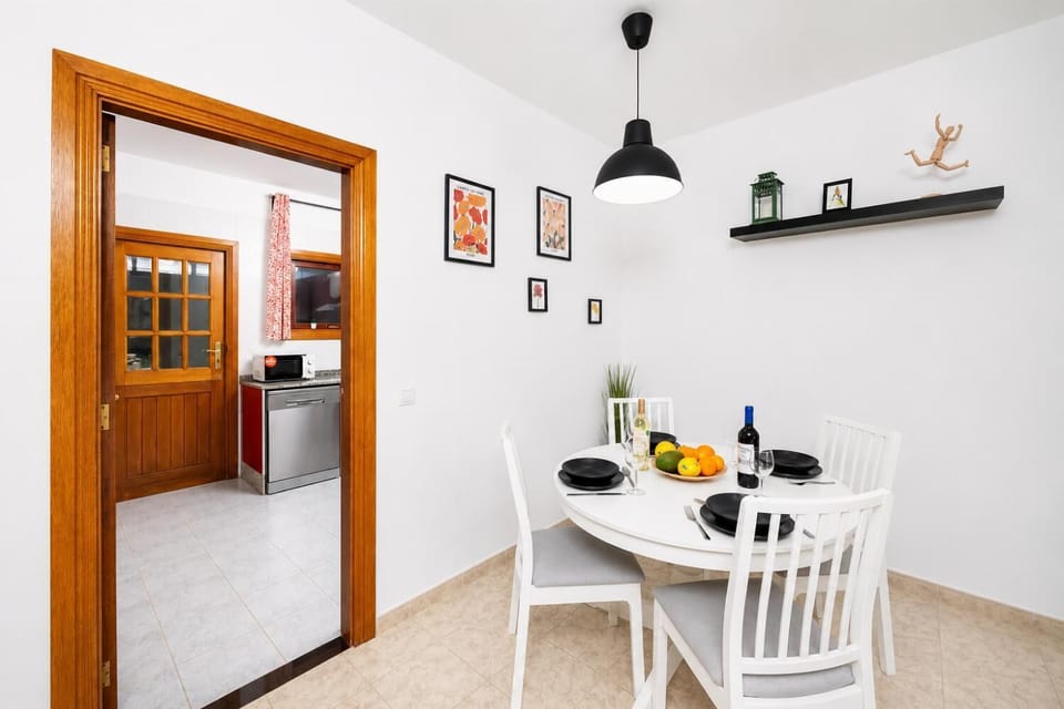 Living room with sofa, dining area, WiFi internet, and satellite TV