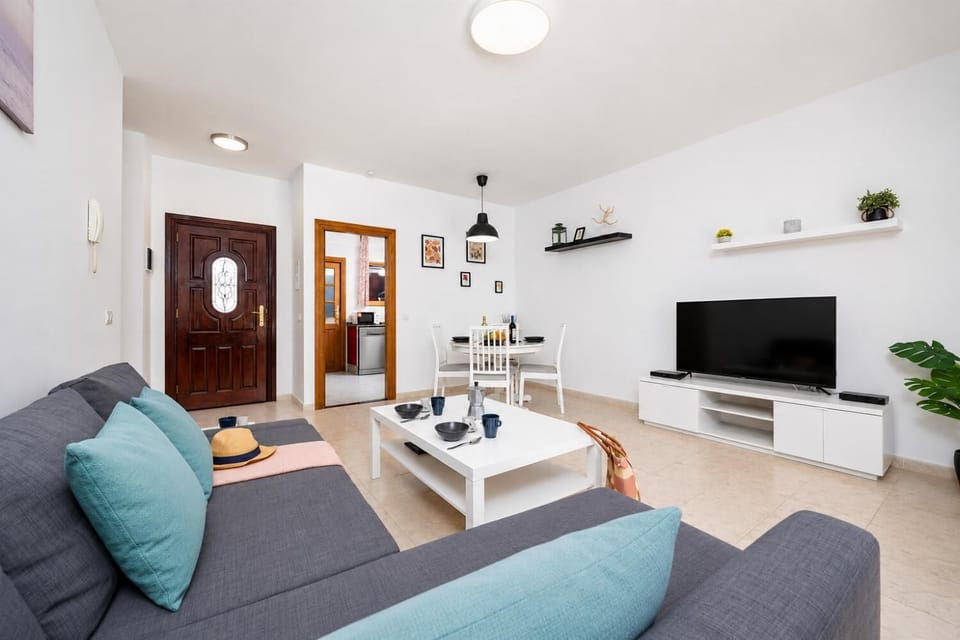Living room with sofa, dining area, WiFi internet, and satellite TV