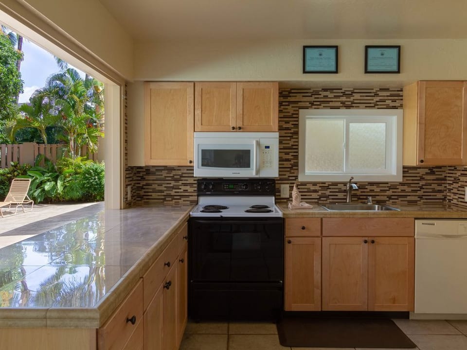Cabana with dishes for use while grilling by the pool. Fridge/stove/dishwasher