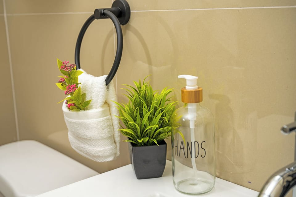 Shower, designer toiletries, hair dryer, towels