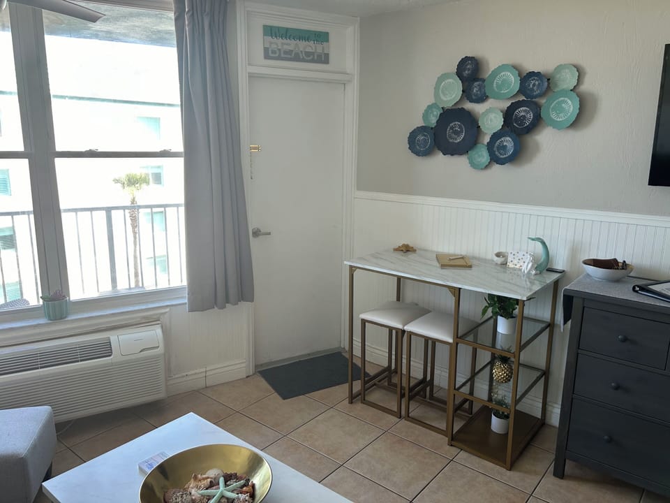 Dining room table and stools leading to the patio.