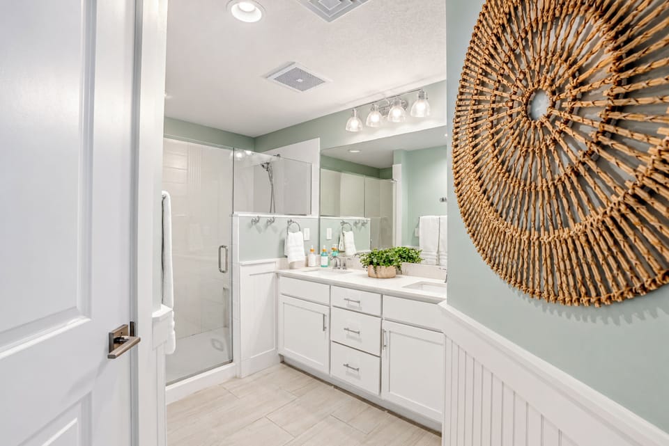 Large over sized walk-in shower with duel shower heads and separate toilet room.