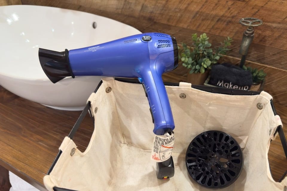 Hair dryer provided in the bathroom.