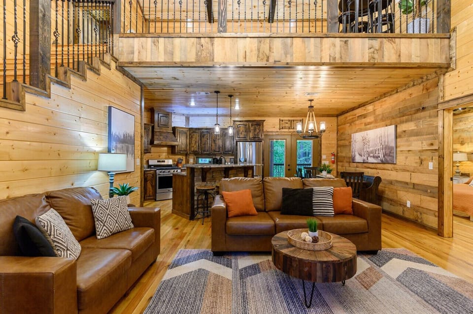 Luxurious lofted space with fireplace, stairs, and elegant décor