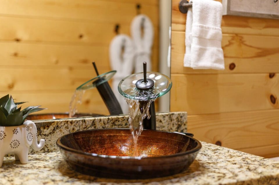 Hand-hammered copper sinks on every vanity — a signature upgrade you`ll notice every day.