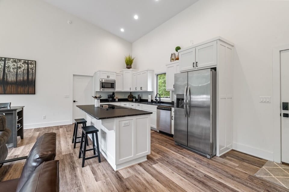 Spacious kitchen with island and full-size stainless appliances.