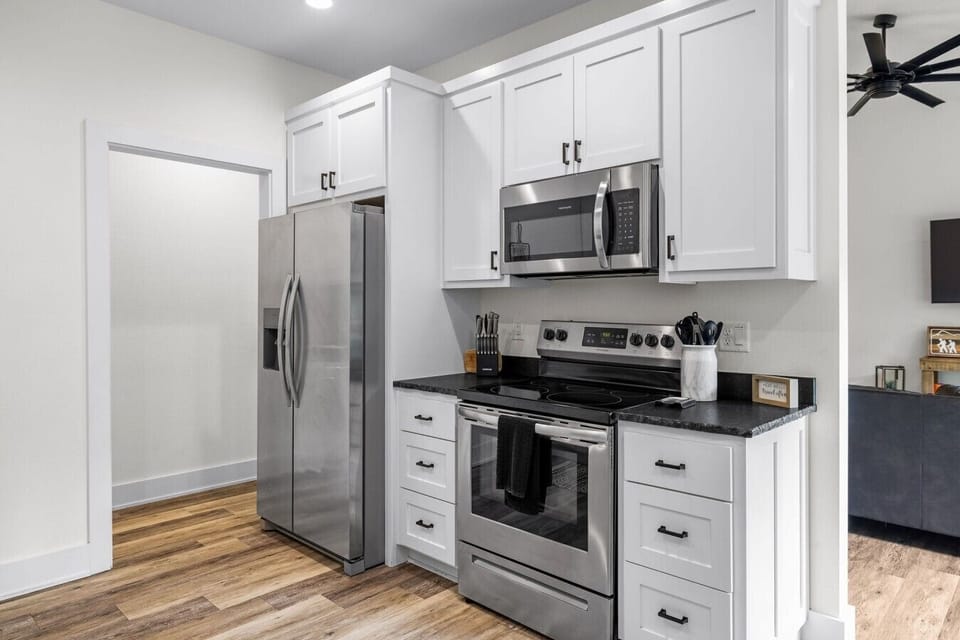 Fully equipped modern kitchen with full-size stainless appliances.