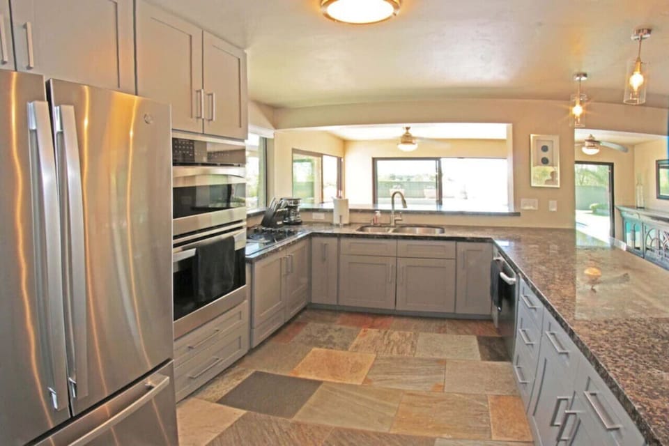Well-appointed kitchen with stainless steel appliances and backyard views