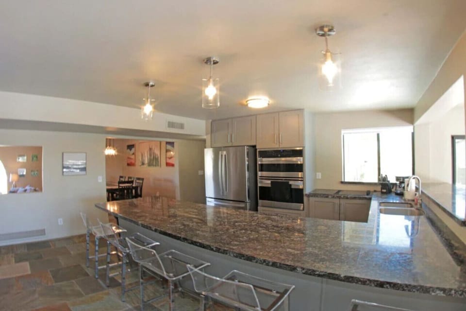 Spacious, well-appointed kitchen with peninsula offering seating for five